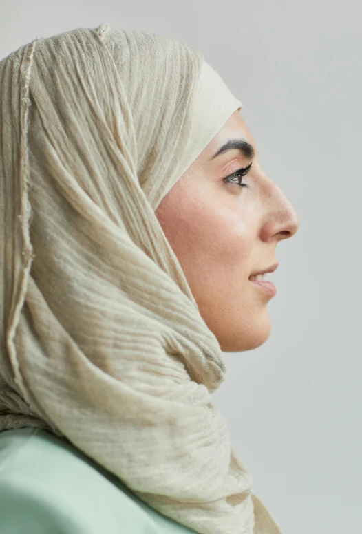 a beautiful young woman wearing a white head covering