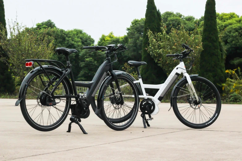 two bicycles are parked on a bench in a park