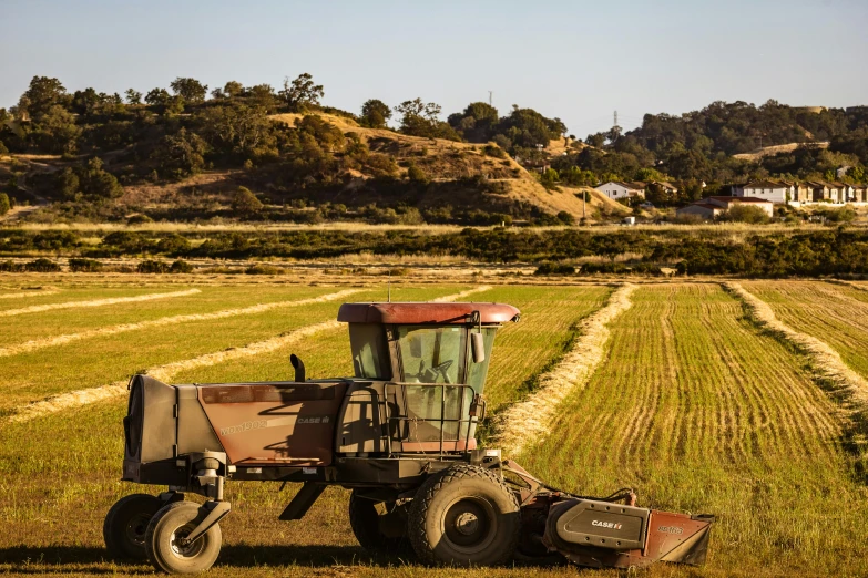 an agricultural tractor with a load driving on the field