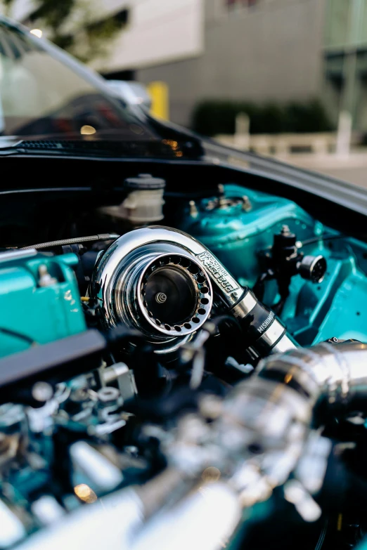 a close up of a turbo engine on the hood of a car