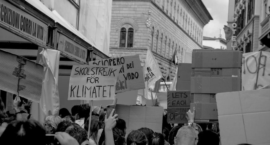 protestors gather in the streets outside of a building in paris