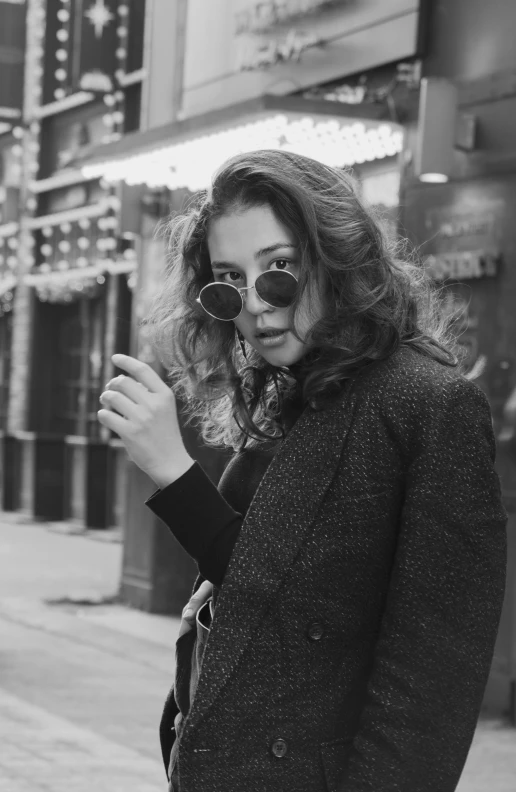 a woman walking down the street while eating soing