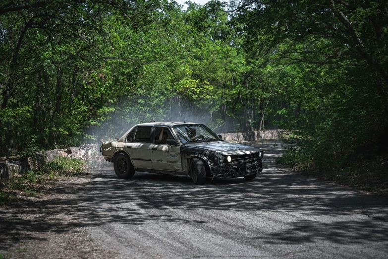 a truck driving down the road in a forest