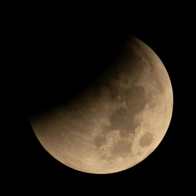 the moon in a dark sky with clouds