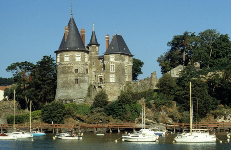 a castle with towers overlooking a river