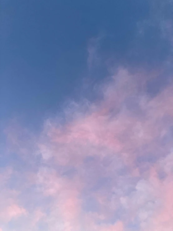 an airplane flying through the sky in a cloud formation