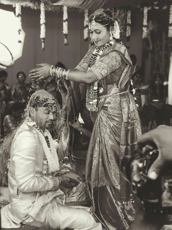 an indian wedding is seen in black and white