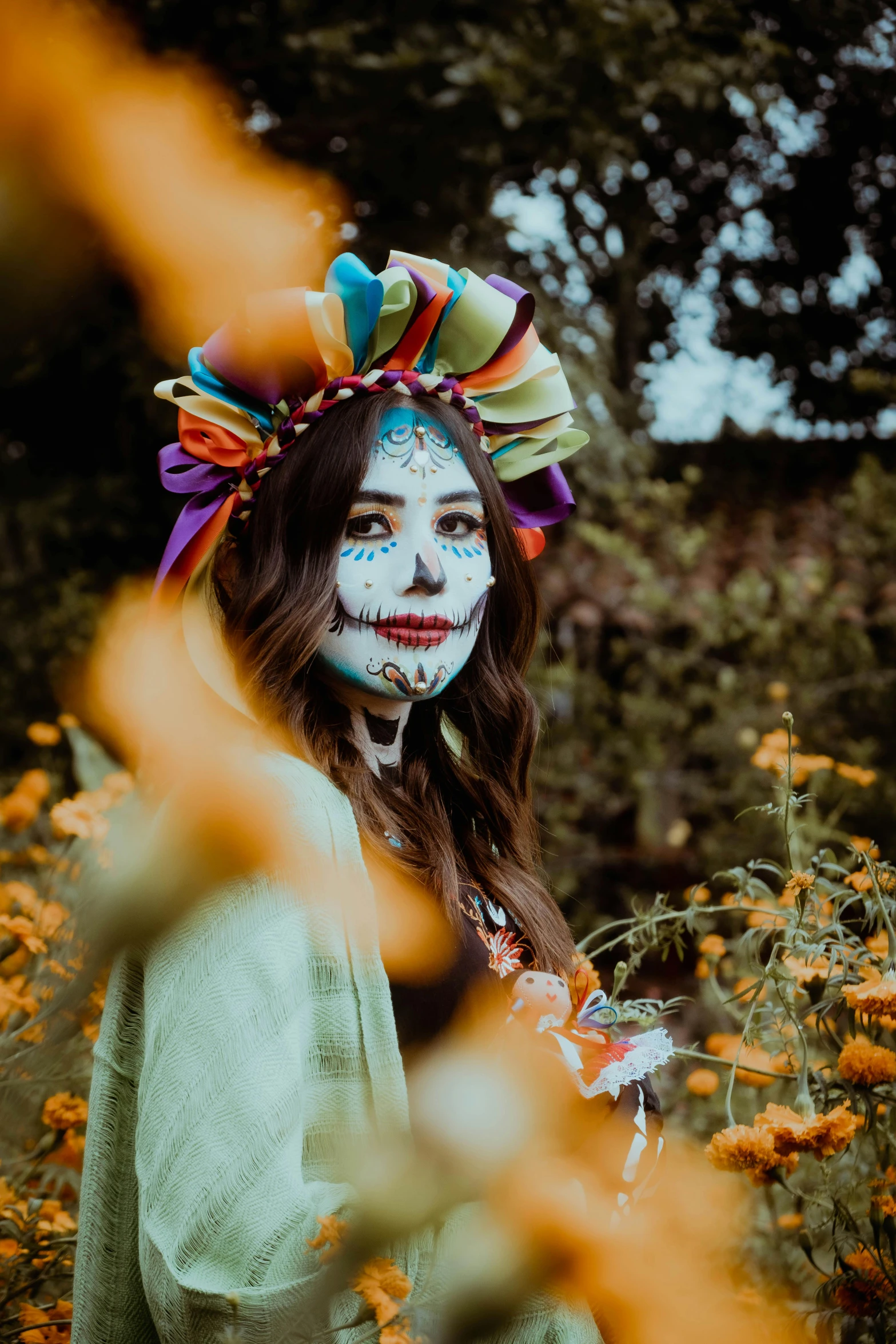 a woman with white makeup and colorful paint