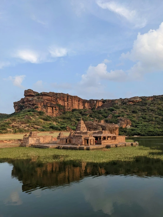 an old water castle is on the shore of a lake