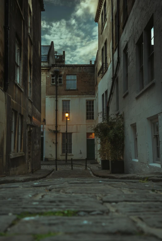 a deserted alley with windows on either side and a lantern in the middle