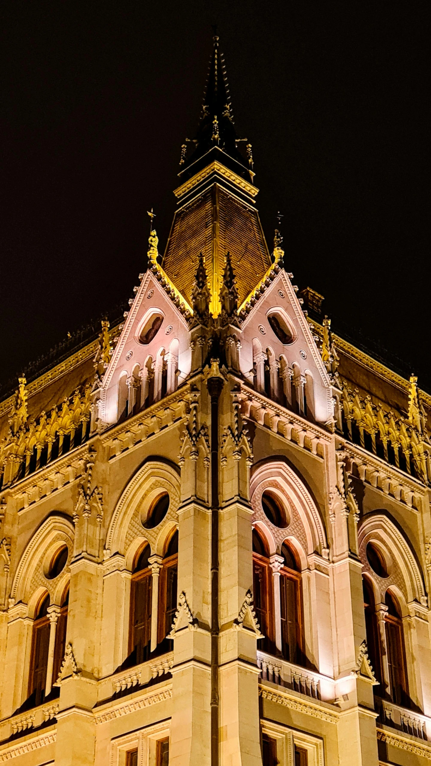 tall building with illuminated tower on side lit up