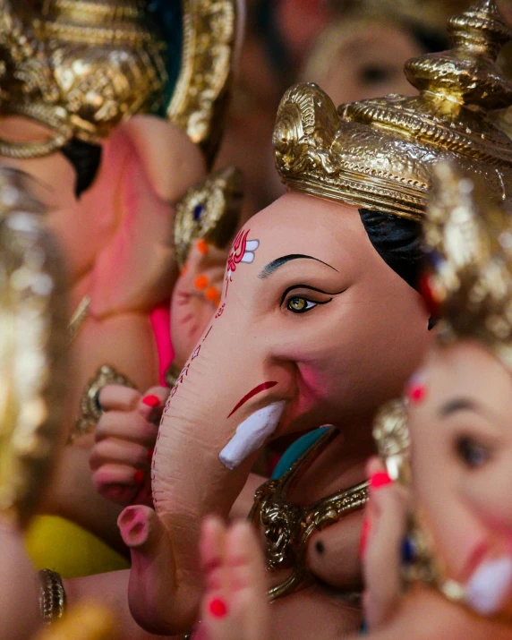 several people are using elephants to decorate the indian deities