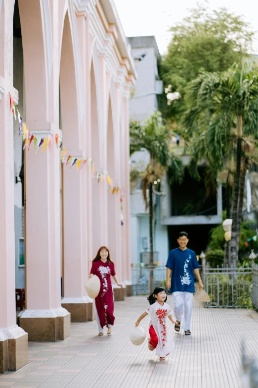 two people in red ones are walking through the street