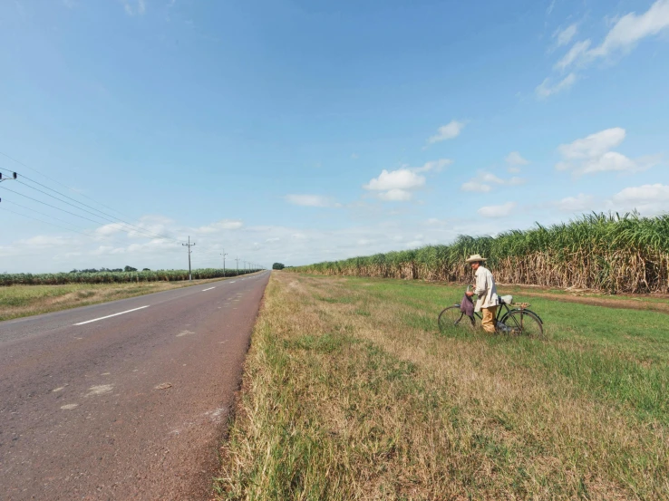 a man is riding his bicycle down the road