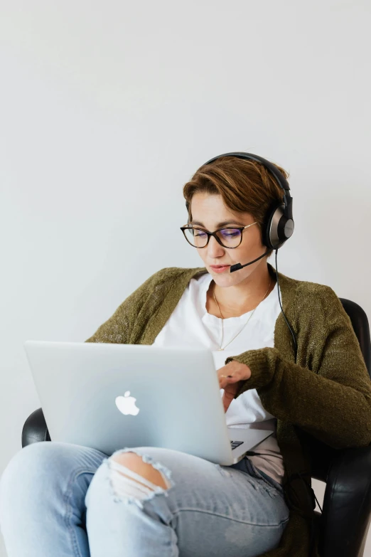 a woman with glasses is on a computer