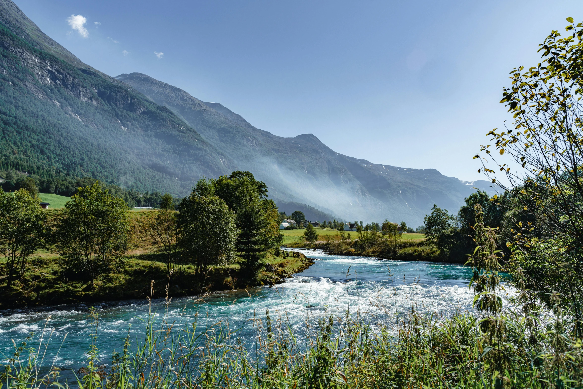 a wide river flowing between two mountains