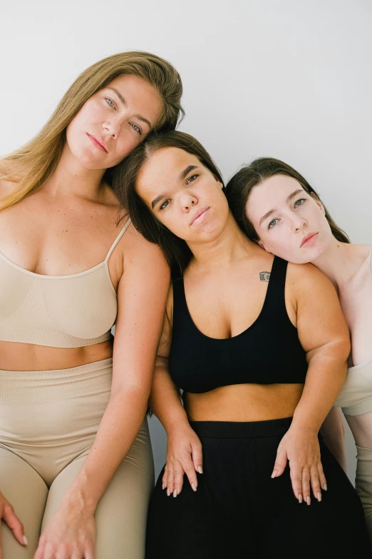 three women are standing together wearing matching underwear