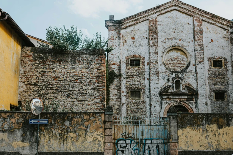 an old building with graffiti on the side of it