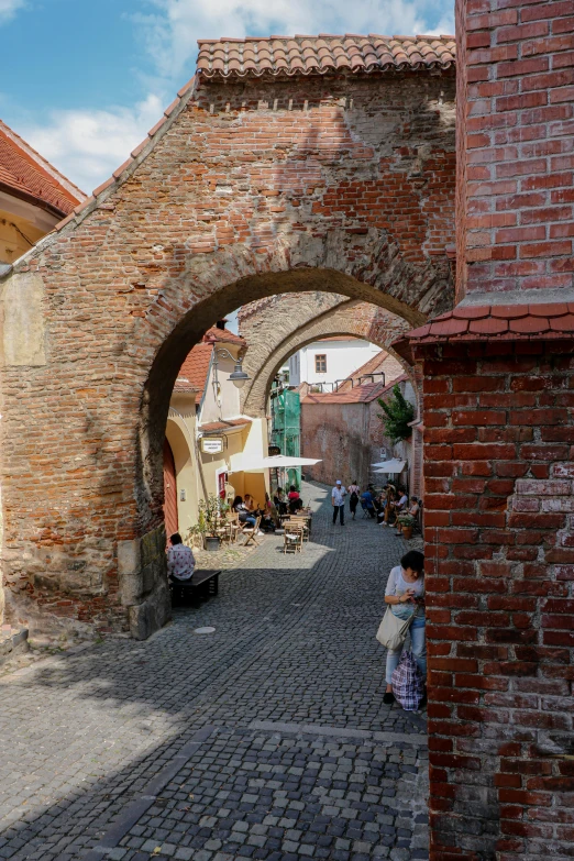 an arch in the side of an old brick building