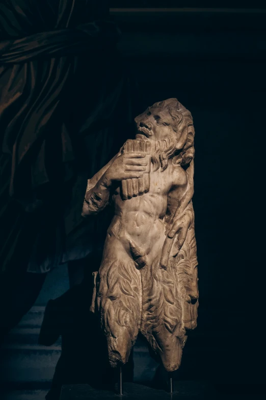 a large stone statue with its arms folded