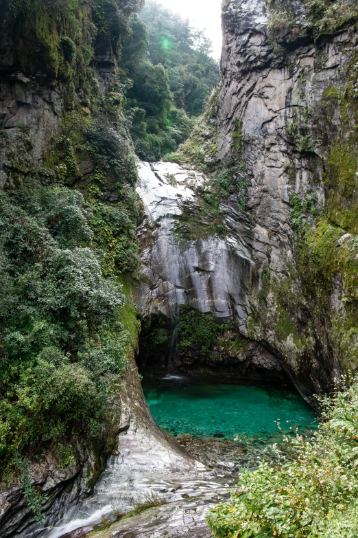 water is running through the canyon between two cliffs