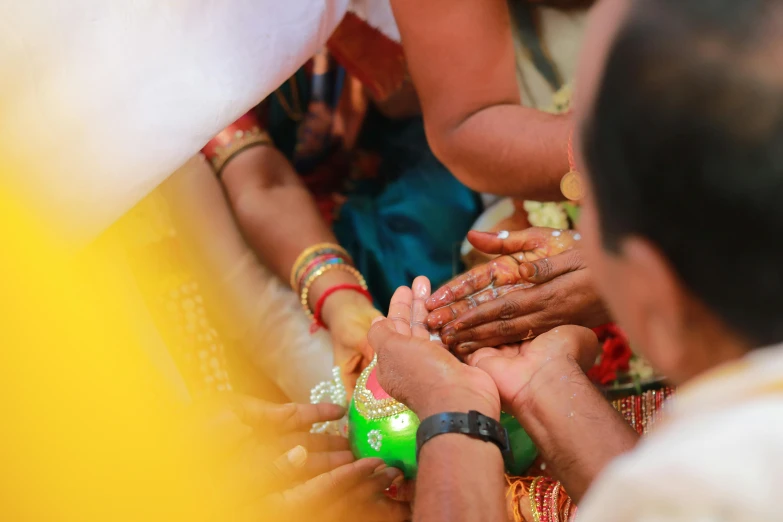 people in colorful clothing and painted hands on each other