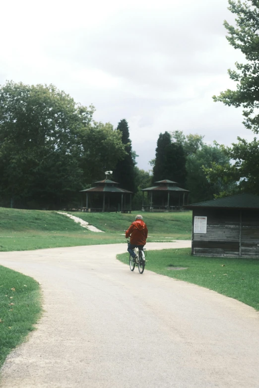 a person rides a bike on a path