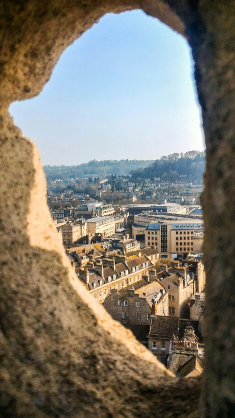 a view of a city from a window in stone