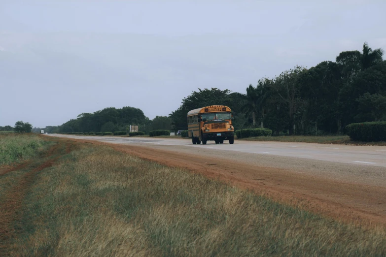 a yellow bus is parked on the side of a road