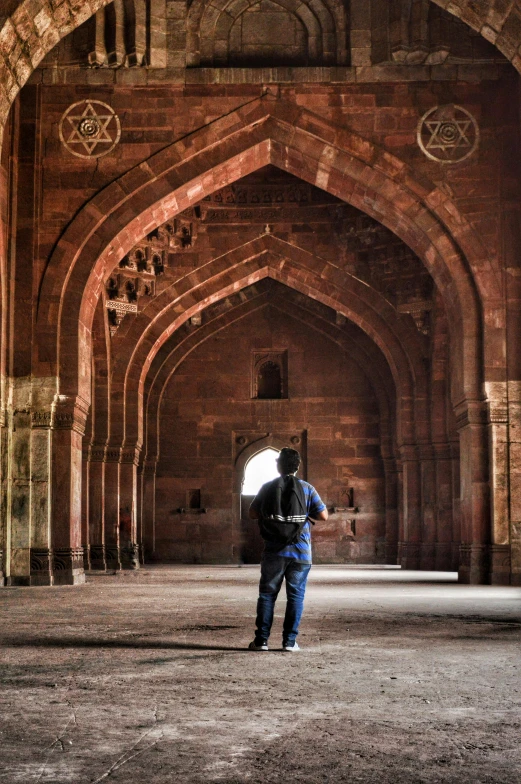 a person standing in an archway under an overpass