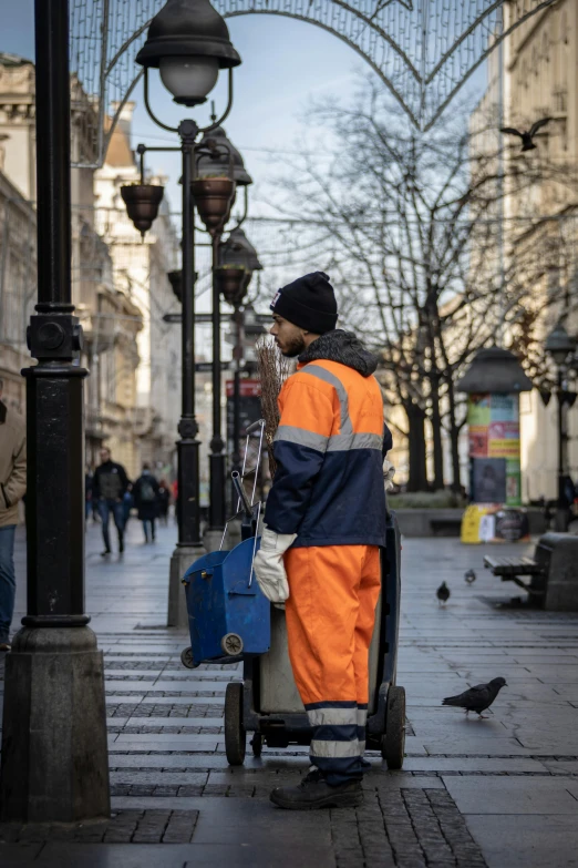 a man is standing with a suitcase and pigeon