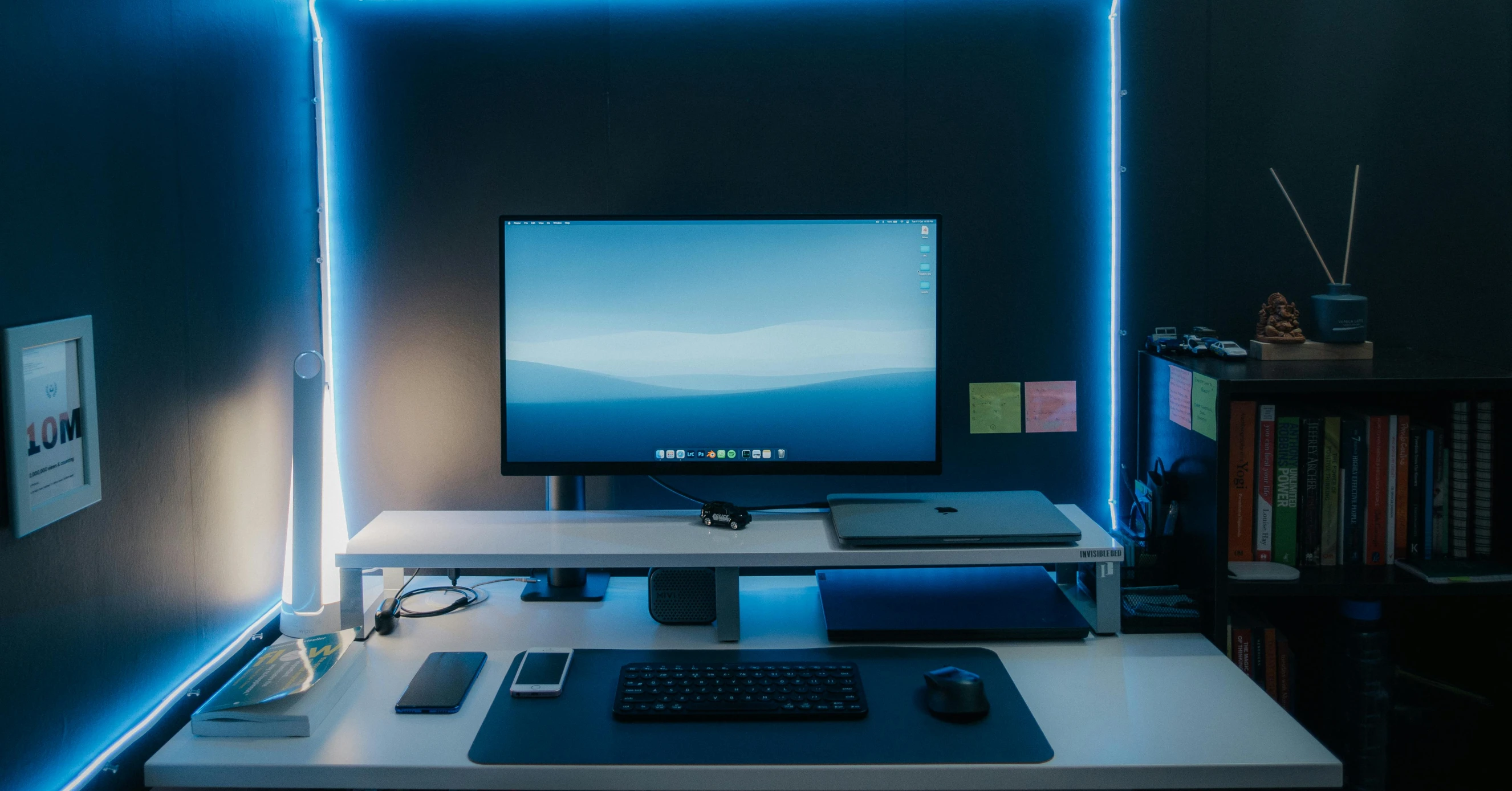 a flat screen computer sitting on top of a white desk