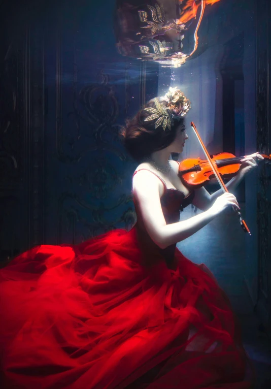 a woman wearing a red dress holding a violin