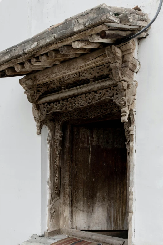 the old carved wooden door with the window open