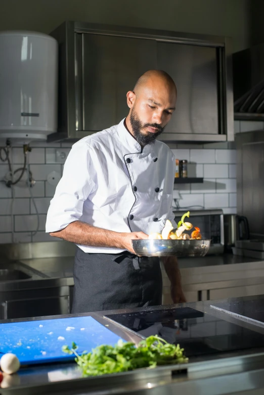 a man in an all white uniform cooks food on a plate