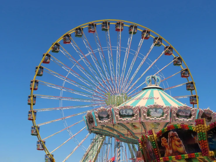 a ferris wheel, carnival rides and blue sky