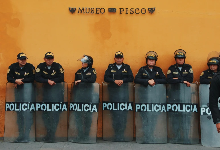 police officers stand at the line of barricades for a break in