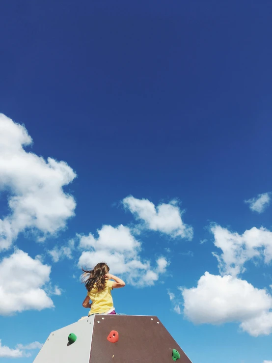 a young lady is sitting on a big skateboard ramp