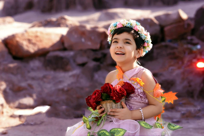 a  with flowers in her hair smiles at the camera