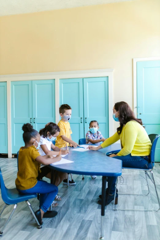 a bunch of s and their mom sit around a table