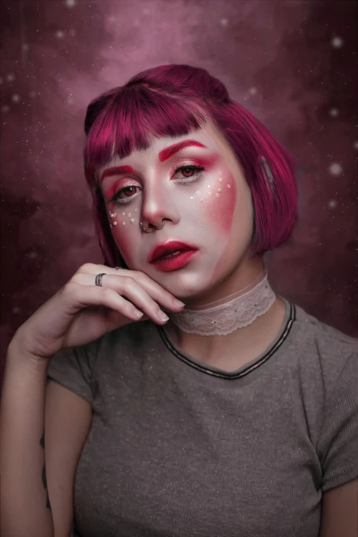 woman with red makeup and freckled hair holding her chin in her hand