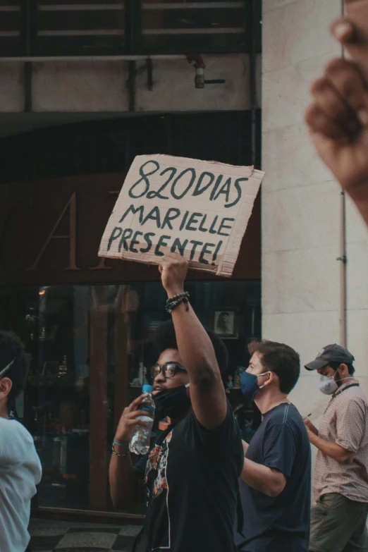 people are holding signs outside a building while others watch