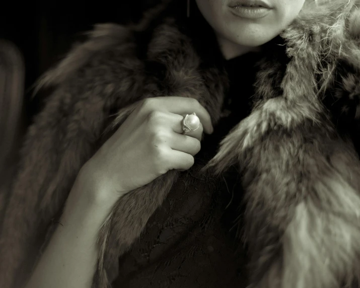 a woman with her hand on her collar