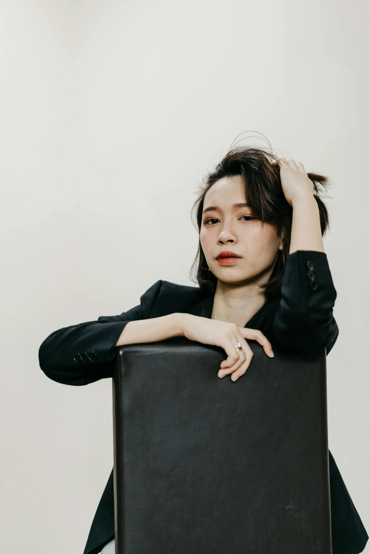 woman holding a briefcase with both hands posing for the camera