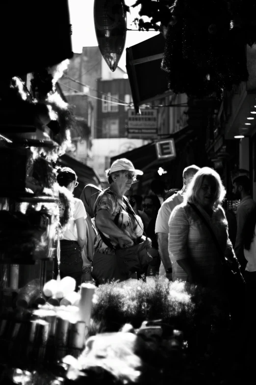 people are on the sidewalk in front of a store