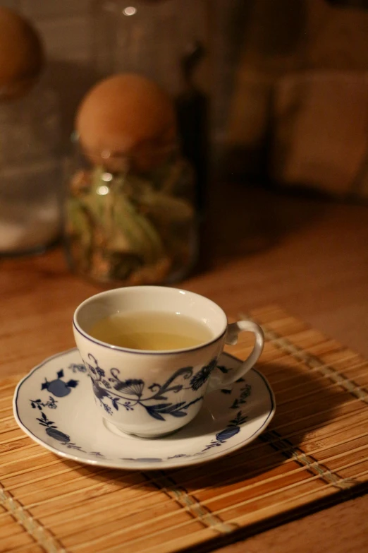 the tea cup has a small saucer with an oriental design