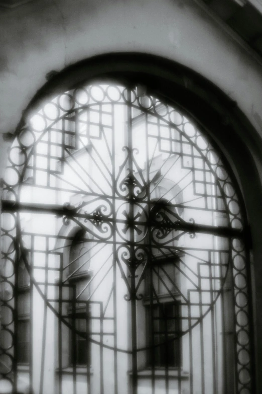 a metal gate with windows and wrought iron on it