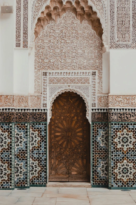 a doorway between two walls decorated with colorful tiles