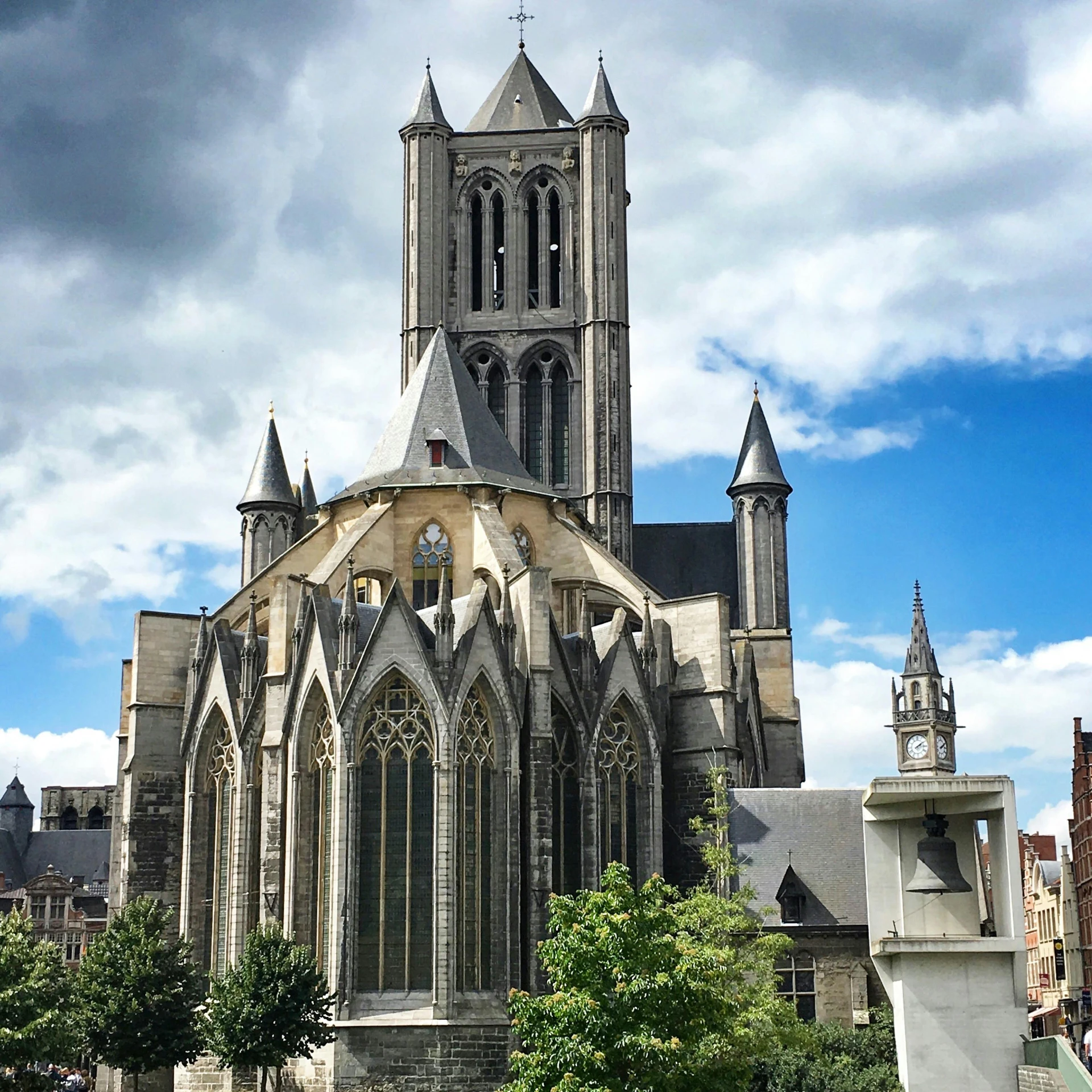 an old building with tall towers against a cloudy sky