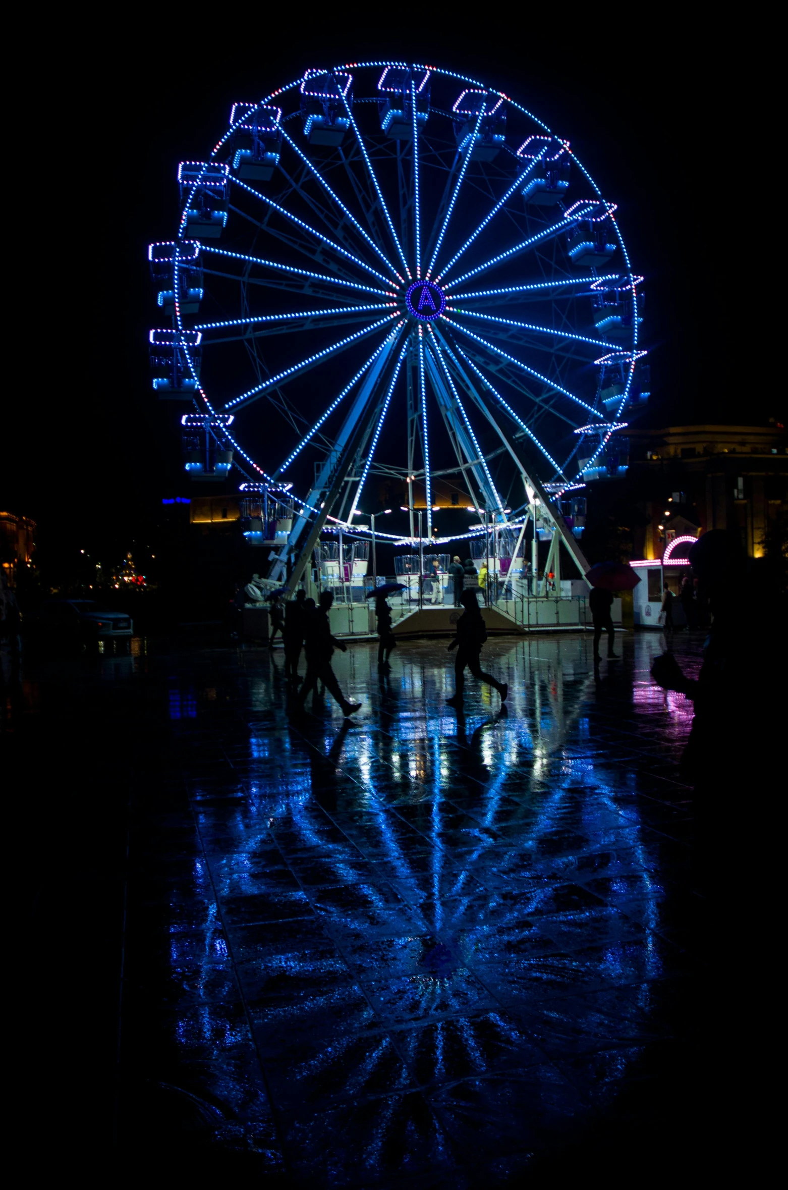 a ferris wheel lit up in the night sky